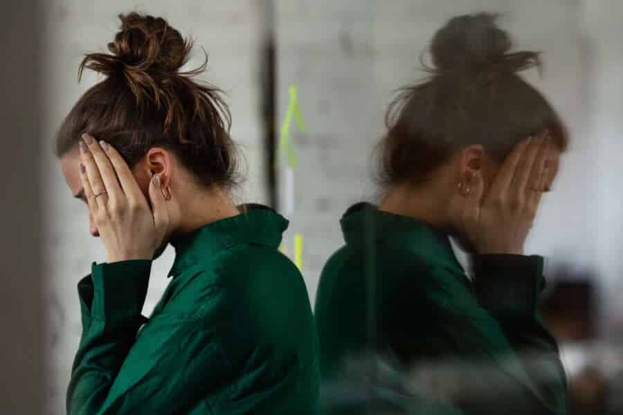 Young stressed out woman in office, having troubles.