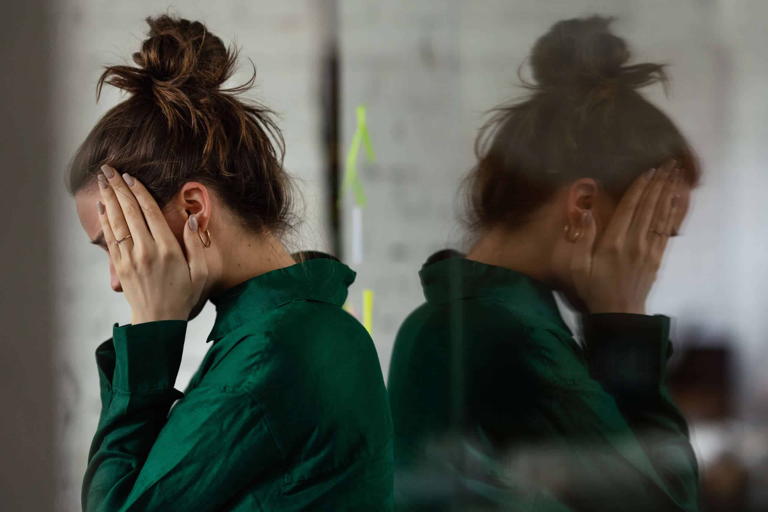 Young stressed out woman in office, having troubles.