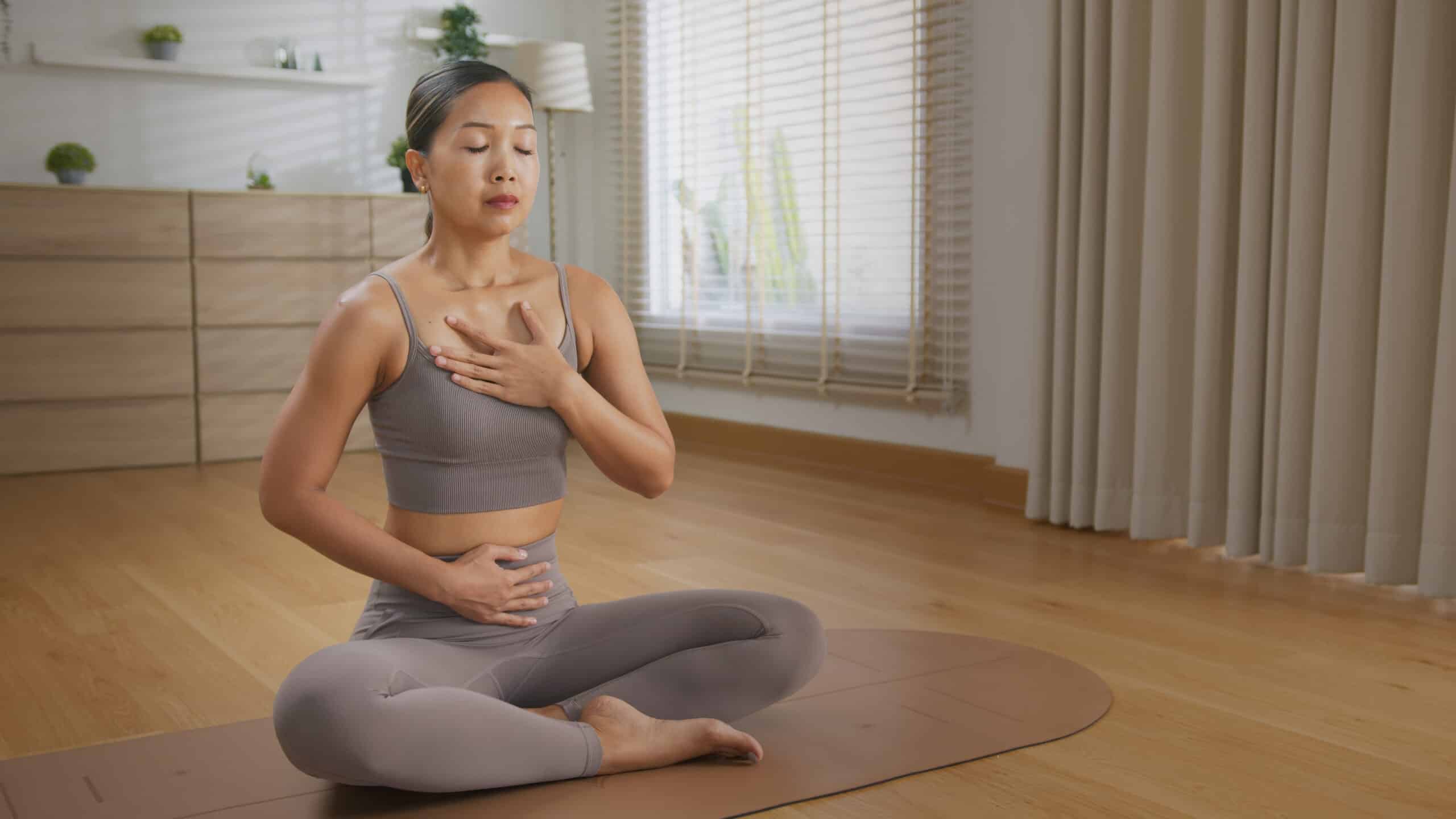 Calm asian woman yoga studio practice sound healing with tibetan singing bowl inspired breathwork meditation, mindful self care mat with soft light and peaceful Sound Healing Tibetan singing bowl